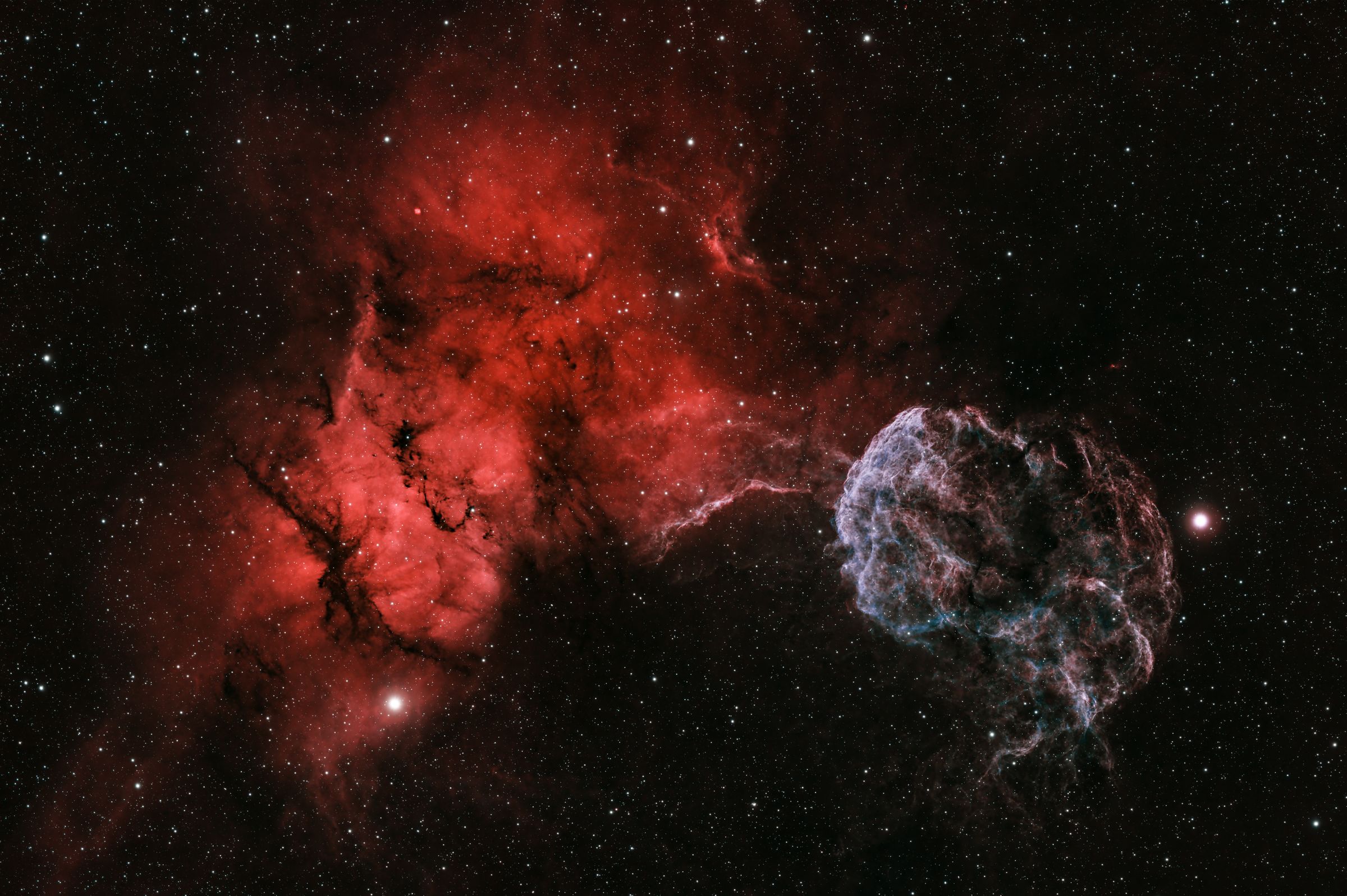 The Jellyfish Nebula and a red emission nebula on a starfield